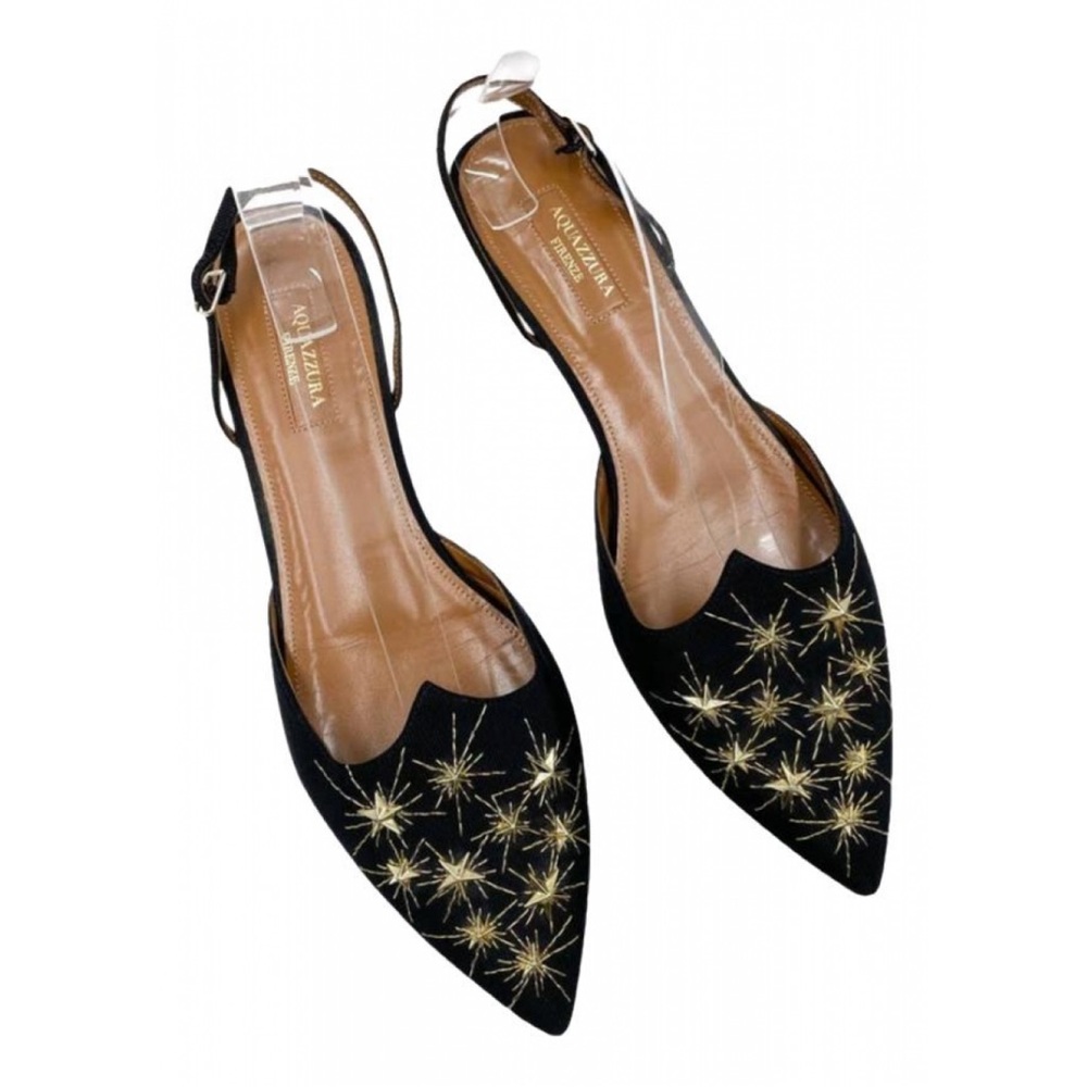 Aquazzura slingback flats with embellished gold star designs.